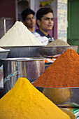 Stacks Of Spices With Stall Holders In Background