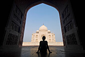 Silhouette Of Woman In Arch Admiring The Taj Mahal