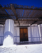 White Washed House And Grass Pergola