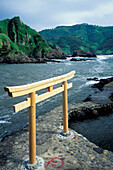 Wooden Tori Gate On Path Along Coastline