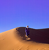 Berber Man Walking In Sand Dunes