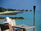 Woman Sitting At Table On Beach