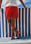 Lifeguard Leaning Against A Wind Break At The Beach