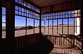 View Through Windows Of Disused Building In Desert Ghost Town