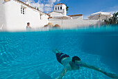 Man Swimming Underwater In Swimming Pool