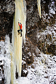 Woman Ice Climber Ascends A Large Icefall In Southcentral Alaska