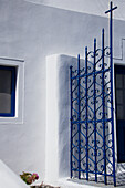 Traditional santorini blue and white an open gate with a cross; Imerovigli cyclades greece