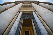 Low Angle View Of St. Peter's Basilica With Large Columns Around A Doorway; Rome, Lazio, Italy