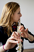 Girl Playing Flute Wearing School Uniform; England