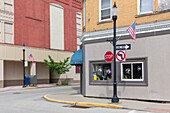 Intersection of roads in a small town with American flags, flying on Memorial Day.