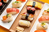 Sushi platter, a selection of raw fish and rice snacks with chopsticks. 