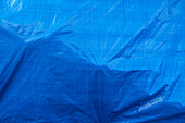 A blue tarpaulin covering a hidden object. 