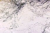 The surface of churning ocean water, overhead view.