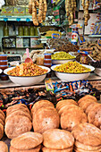 Morocco, Moulay Idris. Market stall selling bread, olives, figs and other products.