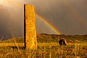 Rainbow over Deer stones with inscriptions, 1000 BC, Mongolia.