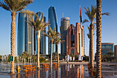 UAE, Abu Dhabi. Etihad Towers and Emirates Palace Hotel fountains