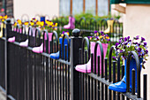 Ireland, County Kerry, Dingle Peninsula, Cloghane, fence decorated with children's boots