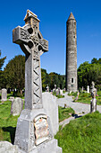 Ireland, County Wicklow, Glendalough, ancient monastic settlement started by St. Kevin, Celtic cross and Round Tower