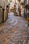 Italy, Sicily, Palermo Province, Geraci Siculo. Winding narrow cobblestone street in the town of Geraci Siculo.