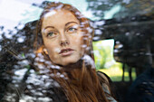 Thoughtful young woman sitting in car
