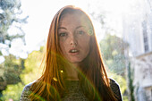 Portrait of serious young woman in public park