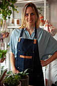 Adult plant store female worker smiling at the camera