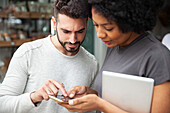 Bakery colleagues setting up social media on smart phone