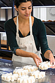 Female Latin-American bakery owner making pastries
