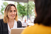 Front view of female business person talking to a colleague