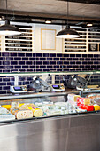 Interior view of grocery store refrigerator full of cheese