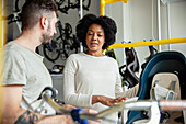 Bicycle store owner talking with African American female customer