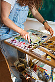 Mid section of painter in studio