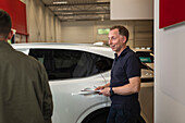 Men in car dealership office