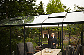 Woman lightning candles in greenhouse