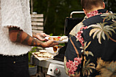 People having barbecue in garden