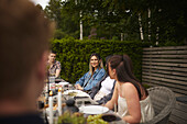 Friends having meal in garden