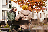 Man and woman sitting on bench