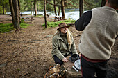 Smiling woman sitting at lake