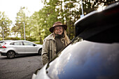 Smiling woman standing near car