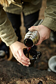 Hands pouring coffee from thermos