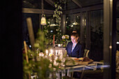 Woman at table using digital tablet