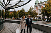 Couple walking in city with shopping bags