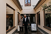 Senior couple with shopping bags walking in passage
