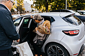 Senior couple getting into car