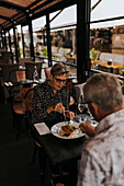 Älteres Paar teilt sich Essen im Restaurant