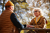 Senior couple at picnic table in park