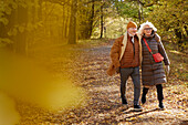 Senior couple walking in autumn park