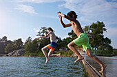 Boys jumping into water