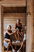 Happy female friends in sauna