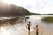 Kinder spielen im See